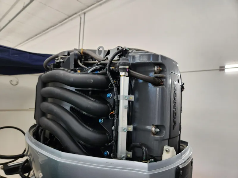 Slide: The Image of Outboard motor of a 2000 World Cat 266 Leisure Cat boat in a garage. - 33
