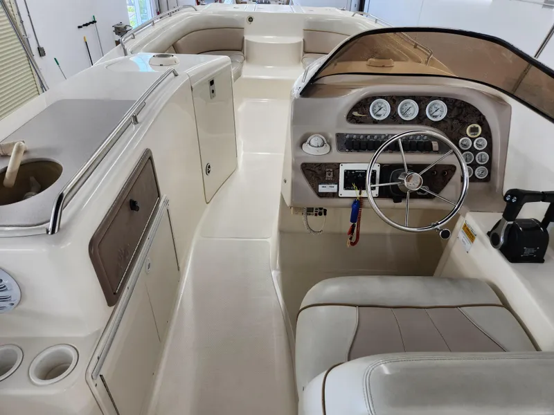 Slide: The Image of 2000 World Cat 266 Leisure Cat boat interior with steering wheel and dashboard controls. - 8