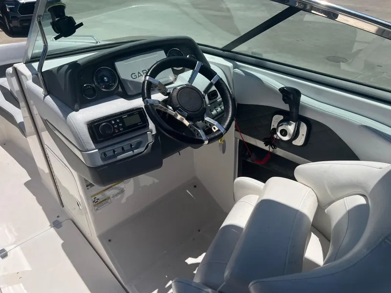 Slide: The Image of 2013 Regal 24 FasDeck RX boat cockpit with steering wheel and control panel. - 10