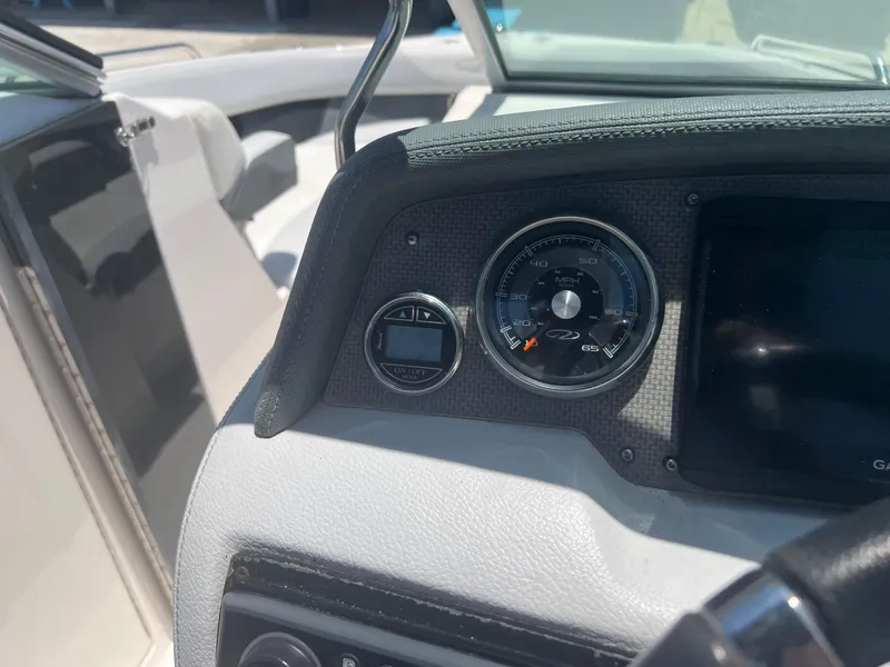 Slide: The Image of Dashboard of a 2013 Regal 24 FasDeck RX boat with speedometer and controls. - 14