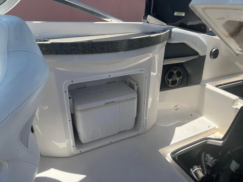 Slide: The Image of 2013 Regal 24 FasDeck RX boat interior with built-in cooler storage. - 16