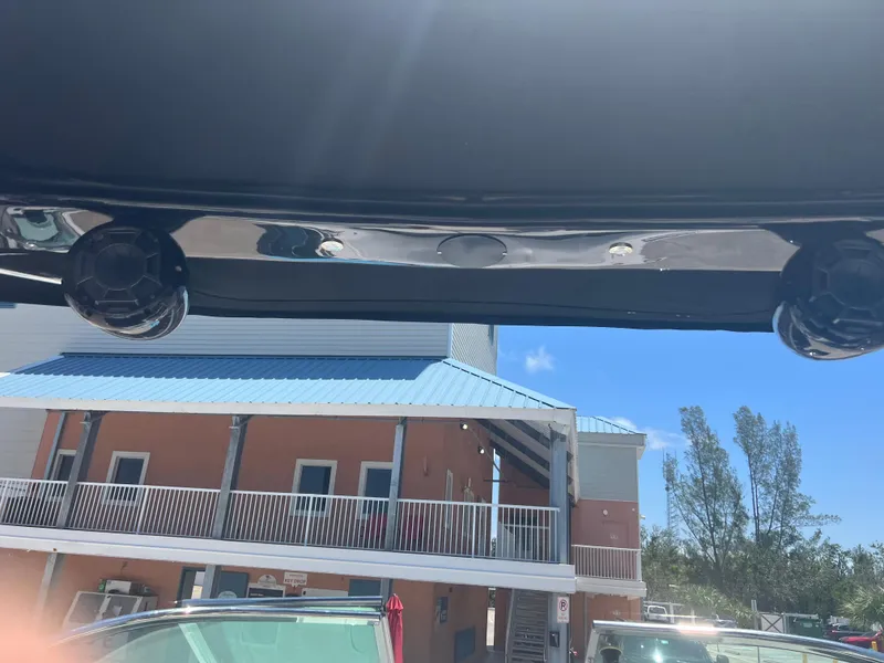 Slide: The Image of 2013 Regal 24 FasDeck RX boat speakers with building and clear sky background. - 17