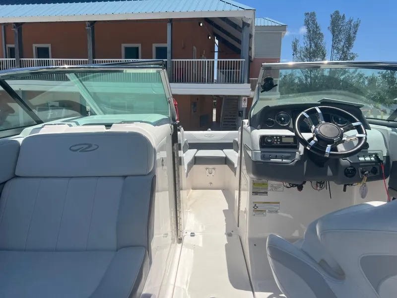 Slide: The Image of Interior view of a 2013 Regal 24 FasDeck RX boat with steering wheel and seating. - 18