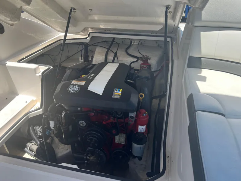Slide: The Image of Engine compartment of a 2013 Regal 24 FasDeck RX boat, showcasing the engine and interior details. - 20