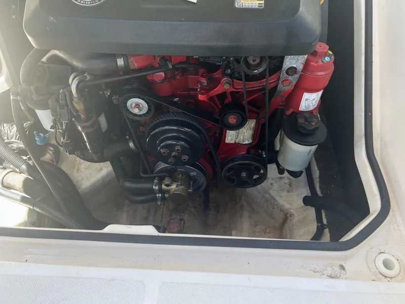 Slide: The Image of Engine compartment of a 2013 Regal 24 FasDeck RX boat, showcasing mechanical components. - 22