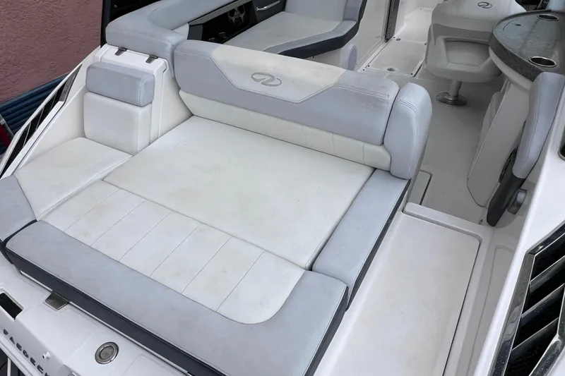 Slide: The Image of 2013 Regal 24 FasDeck RX boat interior with white and gray seating. - 24
