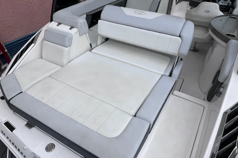 Slide: The Image of 2013 Regal 24 FasDeck RX boat interior with white and gray seating. - 25