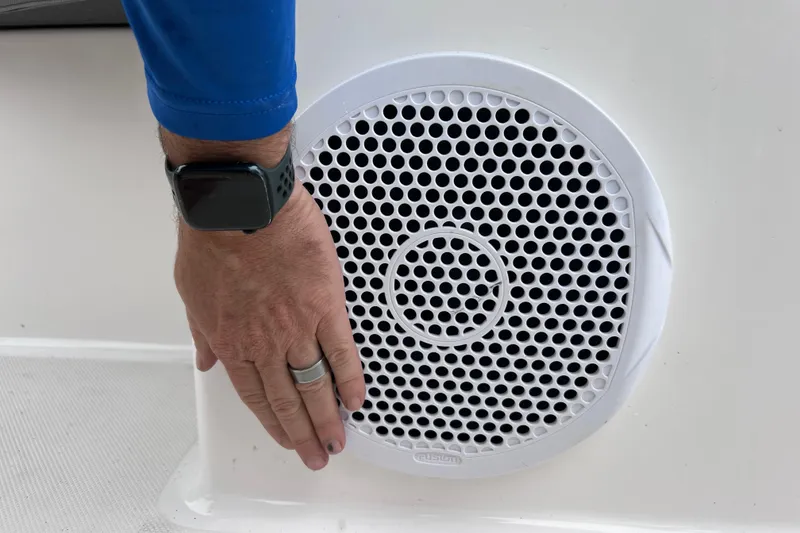 Slide: The Image of Hand adjusting speaker on 2013 Regal 24 FasDeck RX boat. - 28
