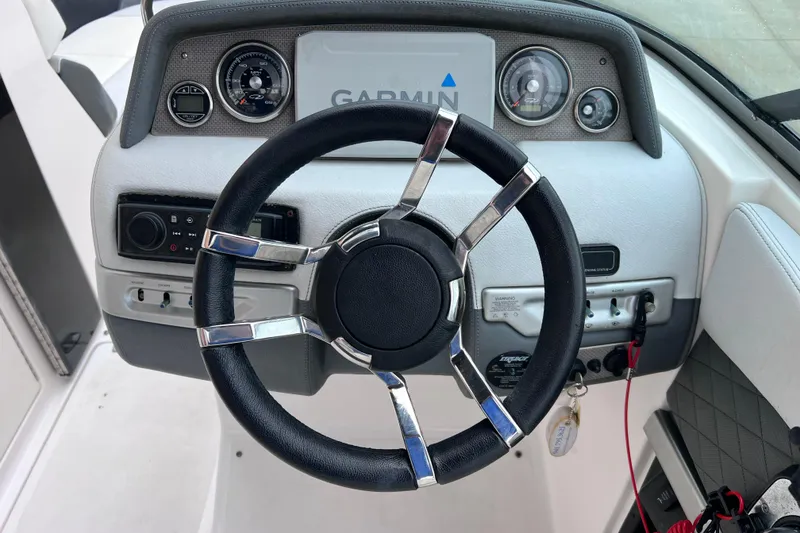 Slide: The Image of Steering wheel and dashboard of 2013 Regal 24 FasDeck RX boat with Garmin display. - 29