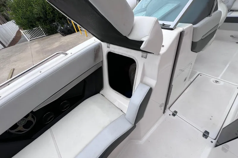 Slide: The Image of 2013 Regal 24 FasDeck RX boat interior with open storage compartment and seating. - 32