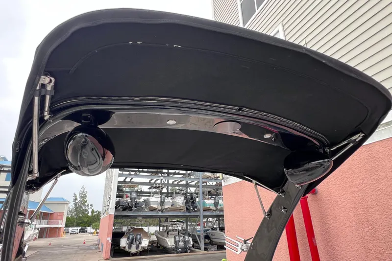 Slide: The Image of 2013 Regal 24 FasDeck RX boat canopy with speakers, docked near storage facility. - 36