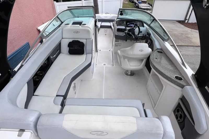 Slide: The Image of 2013 Regal 24 FasDeck RX boat interior with white seating and modern dashboard. - 39