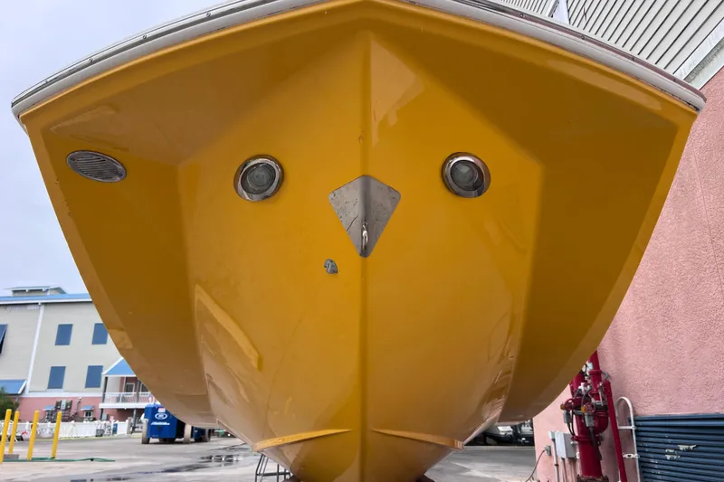 Slide: The Image of Yellow 2013 Regal 24 FasDeck RX boat hull, docked in a marina setting. - 49