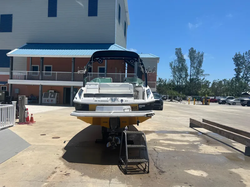 Slide: The Image of 2013 Regal 24 FasDeck RX boat on a dock, sunny day, blue sky. - 6