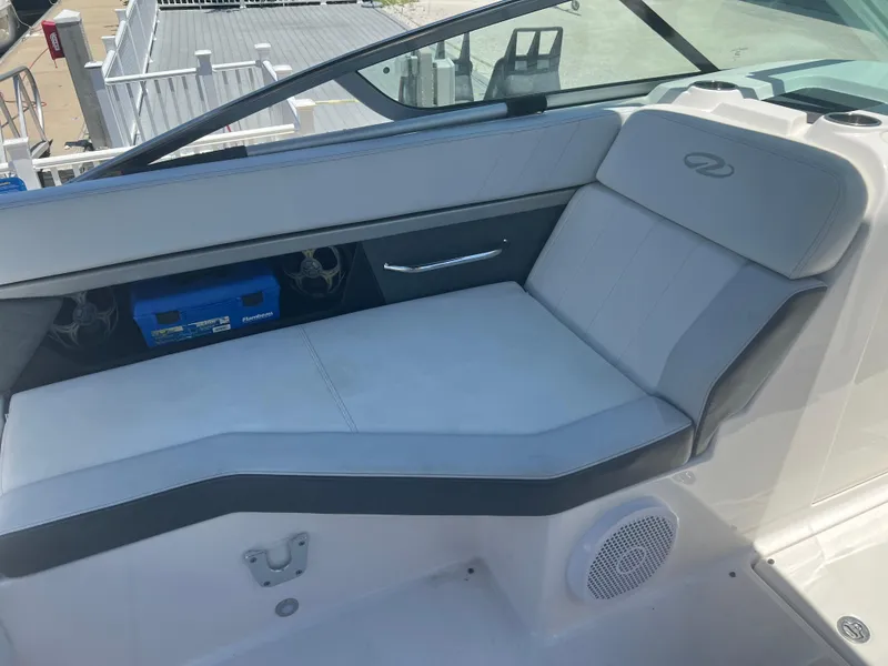 Slide: The Image of 2013 Regal 24 FasDeck RX boat interior with cushioned seating and speakers. - 9