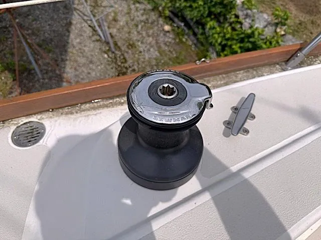 Slide: The Image of Winch on 1993 Tartan 3500 sailboat deck, surrounded by greenery. - 14