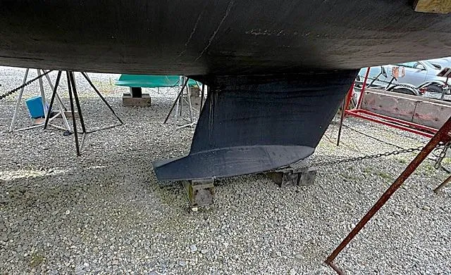 Slide: The Image of Tartan 3500 sailboat keel on gravel, supported by stands, 1993 model. - 19