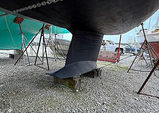 Slide: The Image of 1993 Tartan 3500 sailboat keel on gravel, supported by stands in a boatyard. - 20