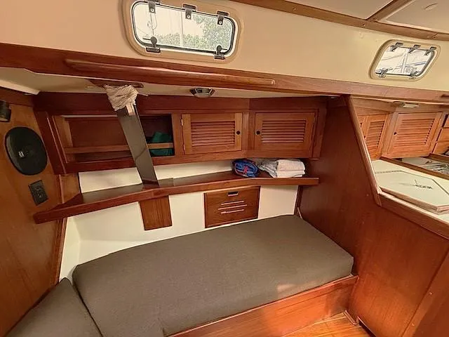 Slide: The Image of Cozy cabin interior of 1993 Tartan 3500 sailboat with wooden finish and storage. - 27