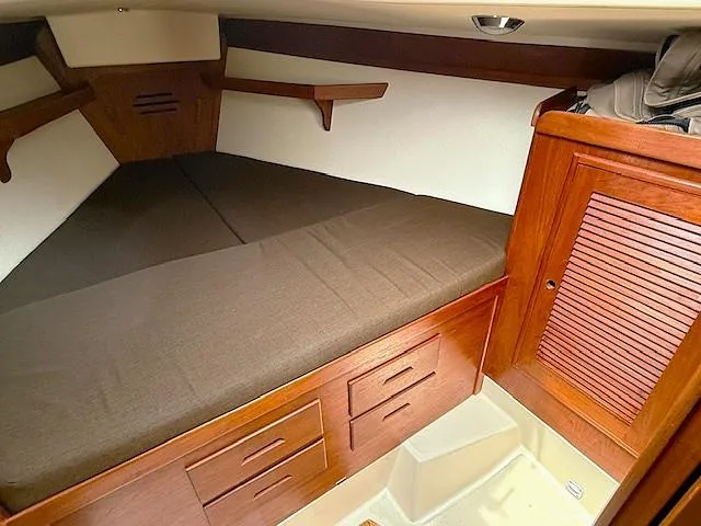 Slide: The Image of Cozy cabin interior of 1993 Tartan 3500 sailboat with wooden storage and bed. - 29