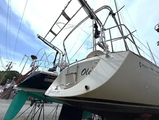 Slide: The Image of Sailboats in a marina, featuring a 1993 Tartan 3500 model, with clear blue skies. - 3