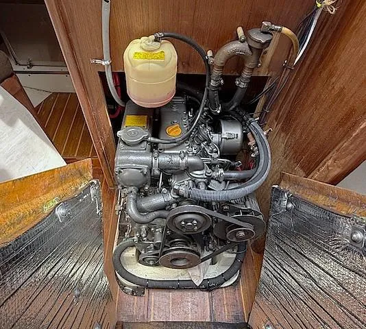 Slide: The Image of Engine compartment of a 1993 Tartan 3500 sailboat, showcasing detailed mechanical components. - 33