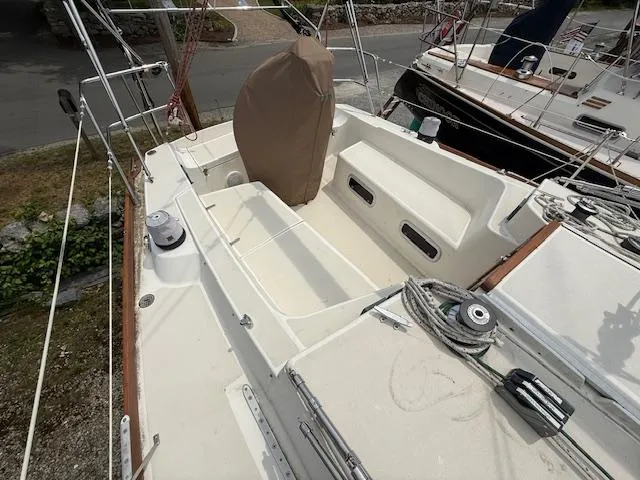 Slide: The Image of 1993 Tartan 3500 sailboat cockpit with covered wheel, ropes, and seating area. - 4