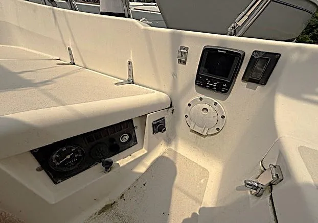 Slide: The Image of 1993 Tartan 3500 boat cockpit with navigation instruments and control panel. - 7