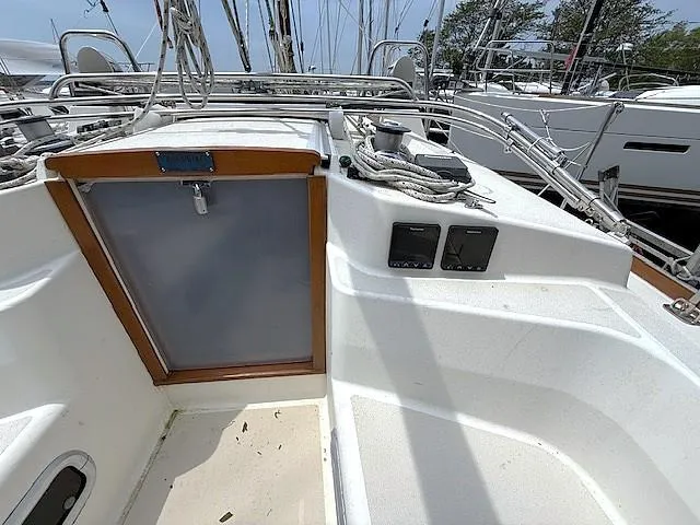 Slide: The Image of Cockpit of a 1993 Tartan 3500 sailboat with control panels and ropes. - 8
