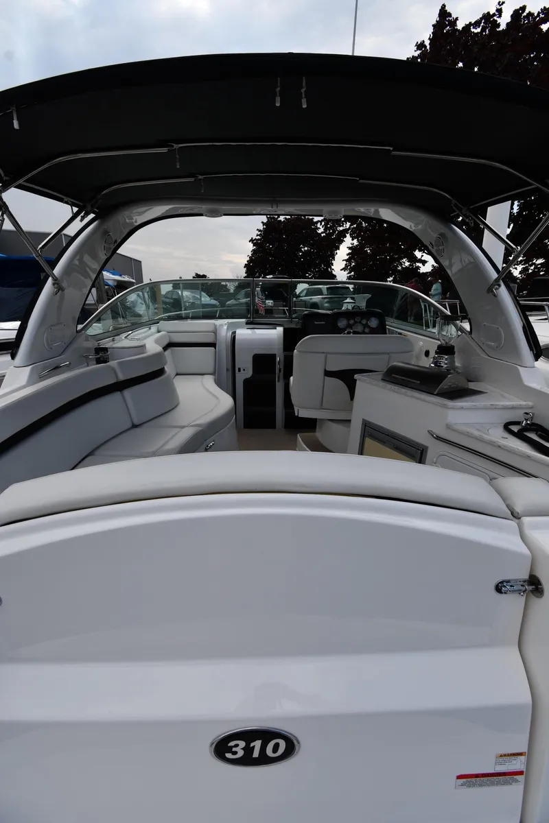 Slide: The Image of 2014 Rinker 310 Express Cruiser interior with seating and helm, showcasing luxury design. - 10
