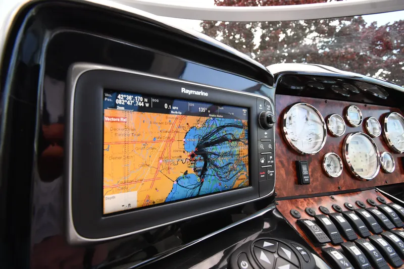 Slide: The Image of Dashboard of 2014 Rinker 310 Express Cruiser with navigation system and gauges. - 14