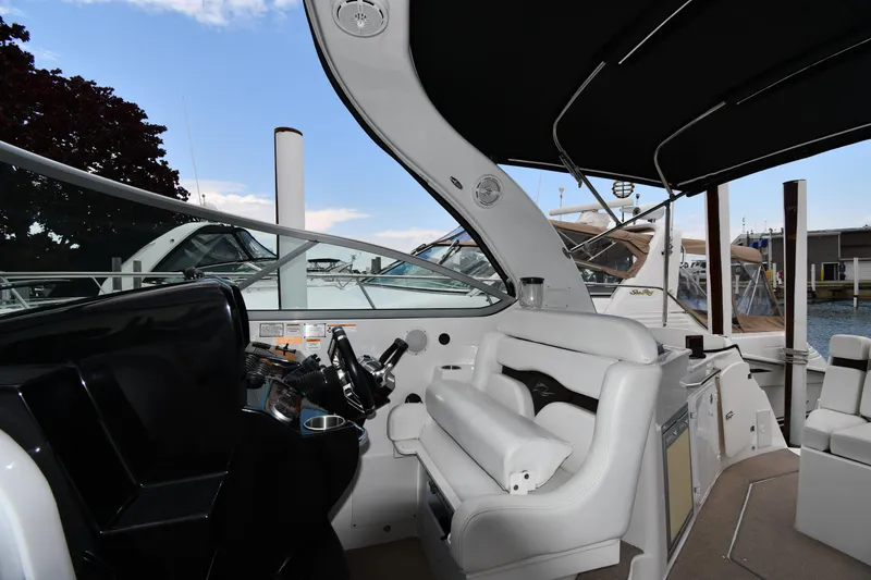 Slide: The Image of 2014 Rinker 310 Express Cruiser interior with helm and seating area. - 18