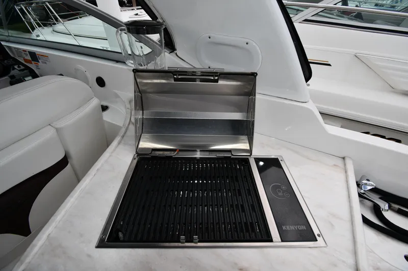 Slide: The Image of 2014 Rinker 310 Express Cruiser with Kenyon grill on deck. - 27