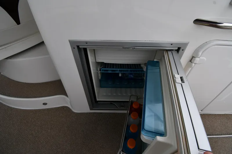 Slide: The Image of Mini fridge on 2014 Rinker 310 Express Cruiser, stocked with beverages. - 28