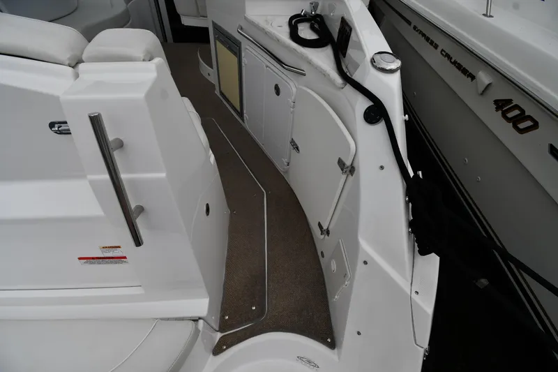 Slide: The Image of 2014 Rinker 310 Express Cruiser interior with seating and storage compartments. - 29