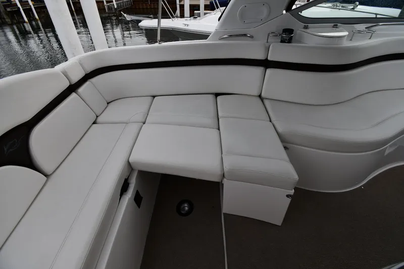 Slide: The Image of 2014 Rinker 310 Express Cruiser interior with white leather seating and sleek design. - 33