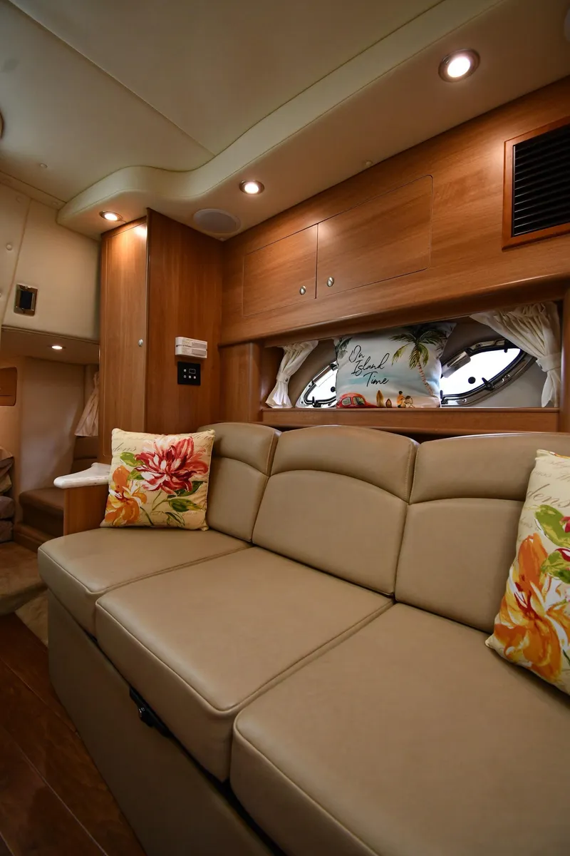 Slide: The Image of Interior of 2014 Rinker 310 Express Cruiser with beige seating and floral cushions. - 47