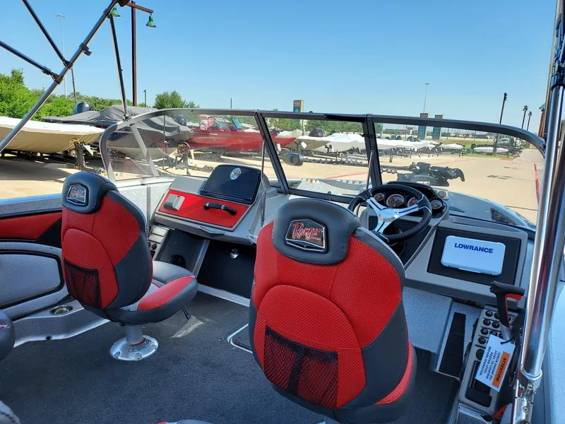 Slide: The Image of 2025 Ranger 1850MS boat interior with red seats, steering wheel, and Lowrance navigation system. - 3