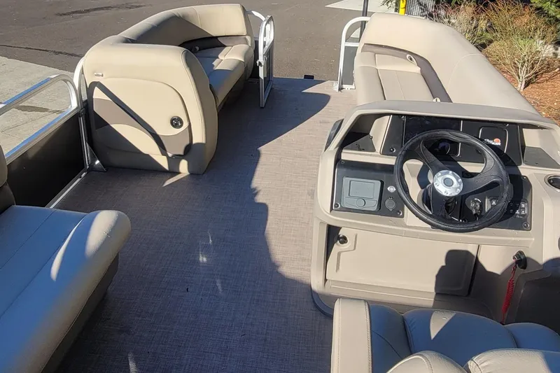 Slide: The Image of 2025 Sun Tracker Party Barge 18 DLX interior with steering console and seating. - 5