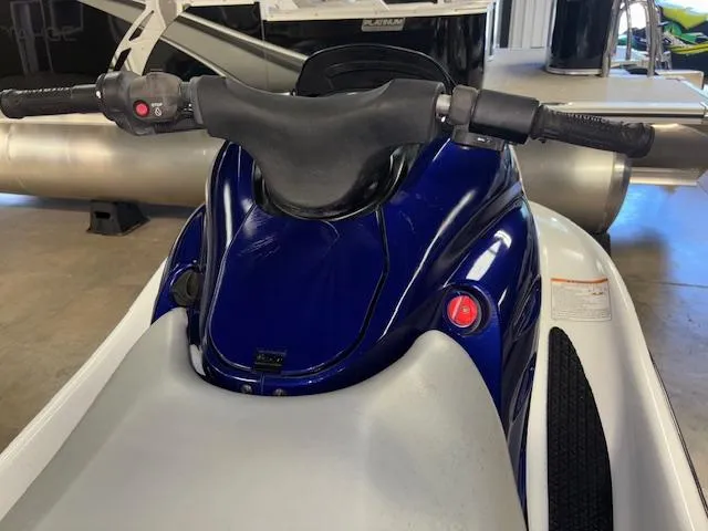 Slide: The Image of 2001 Yamaha WaveRunner GP1200R jet ski, blue and white, handlebars view in a garage setting. - 12