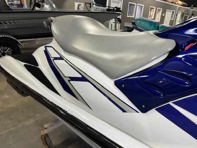 Slide: The Image of 2001 Yamaha WaveRunner GP1200R jet ski with blue and white design in showroom. - 13