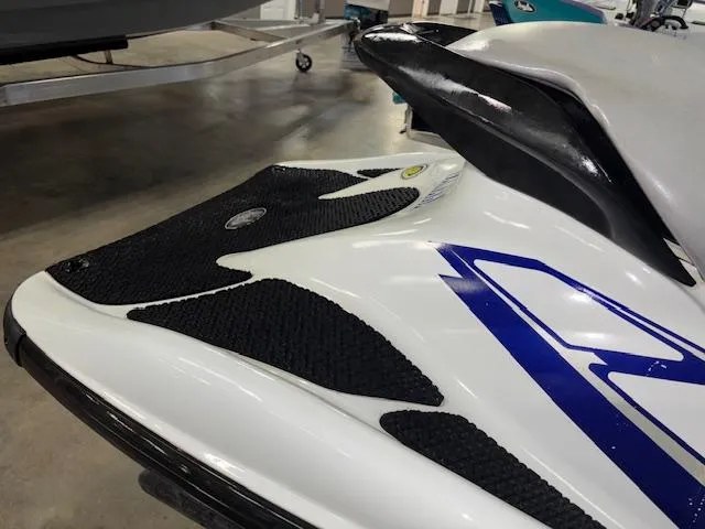 Slide: The Image of 2001 Yamaha WaveRunner GP1200R jet ski, white with blue accents, in a showroom. - 14