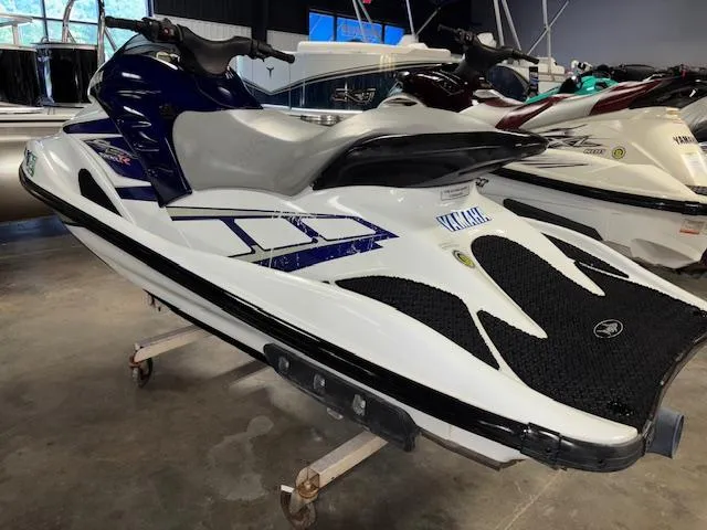 Slide: The Image of 2001 Yamaha WaveRunner GP1200R jet ski in showroom, white and blue design. - 3