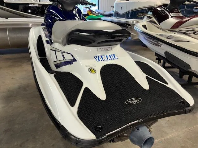 Slide: The Image of 2001 Yamaha WaveRunner GP1200R jet ski in showroom, featuring sleek design and black foot mats. - 5