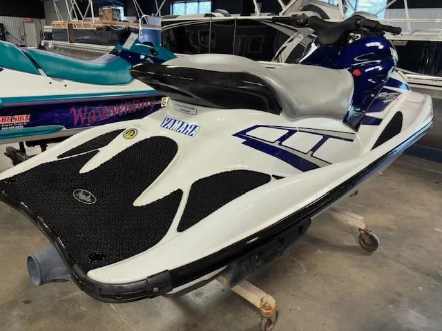 Slide: The Image of 2001 Yamaha WaveRunner GP1200R jet ski in a showroom, featuring sleek design and vibrant colors. - 6