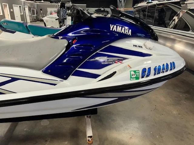 Slide: The Image of 2001 Yamaha WaveRunner GP1200R jet ski in showroom, blue and white design. - 8