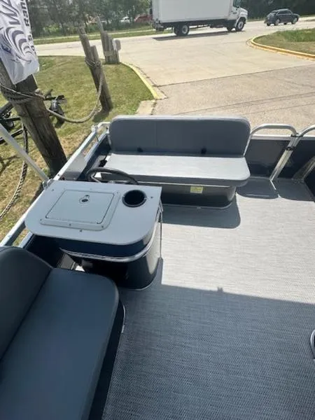 Slide: The Image of 2026 Paddle King Lo Pro Cruiser pontoon boat interior with gray seating and open deck. - 5