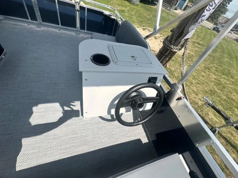 Slide: The Image of 2026 Paddle King Lo Pro Cruiser pontoon boat interior with seating and console. - 6