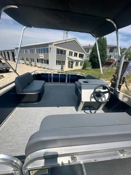 Slide: The Image of 2026 Paddle King Lo Pro Cruiser pontoon boat with spacious seating and steering console. - 8