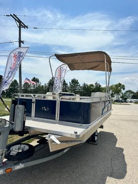 Slide: The Image of 2026 Paddle King Lo Pro Cruiser XL pontoon boat with canopy on a trailer. - 3